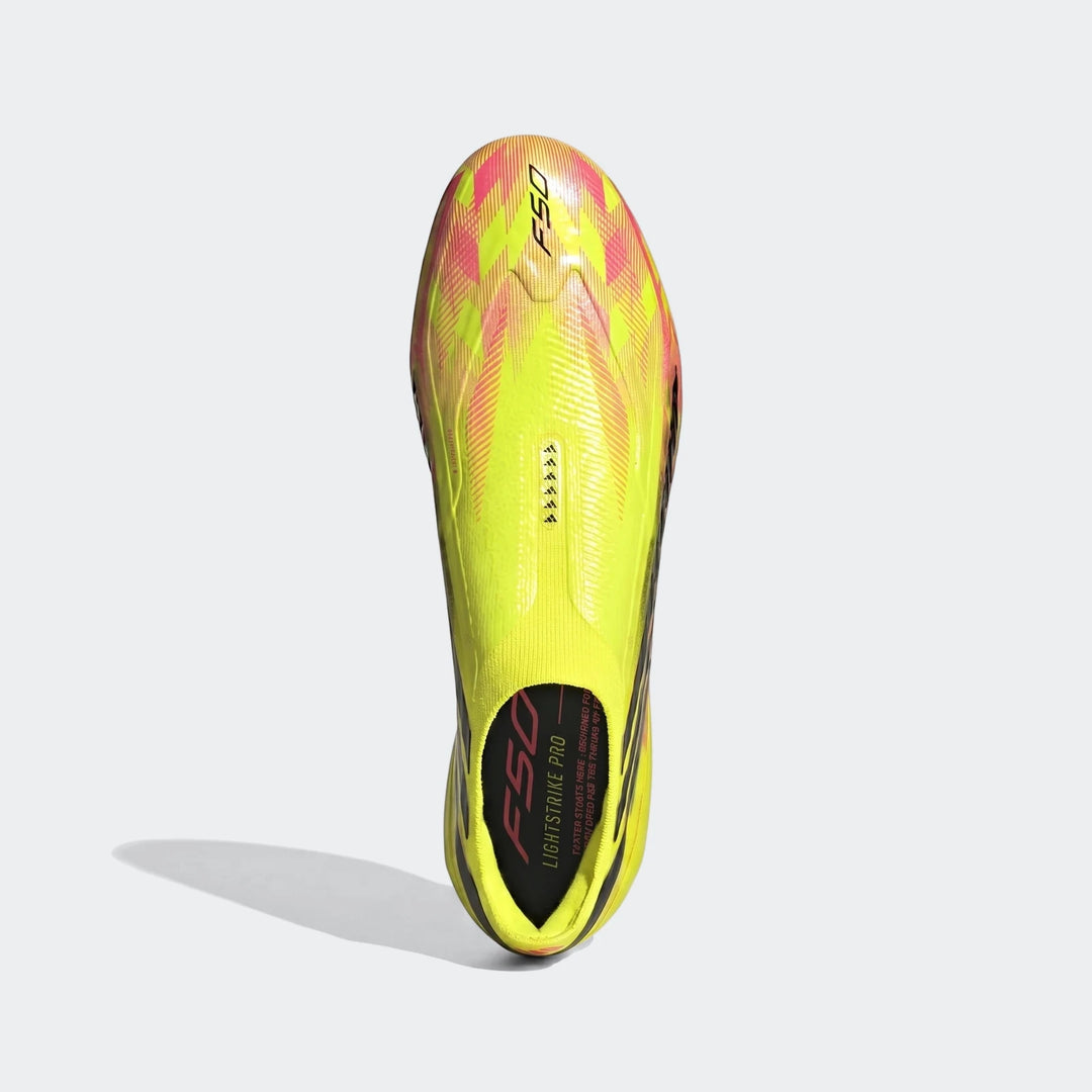 Bright yellow, pink, and black F50 Hyperfast Elite Laceless Firm Ground Boots, shown from an overhead view.