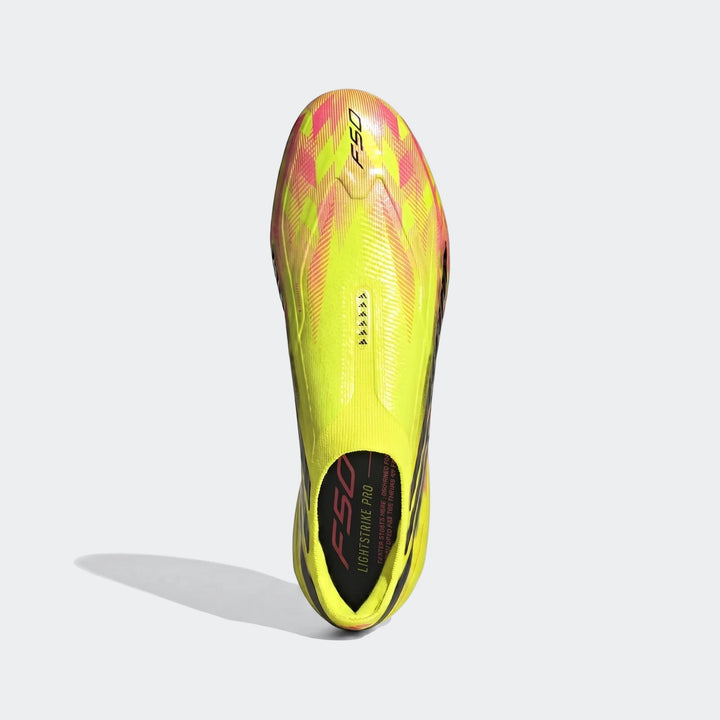 Bright yellow, pink, and black F50 Hyperfast Elite Laceless Firm Ground Boots, shown from an overhead view.