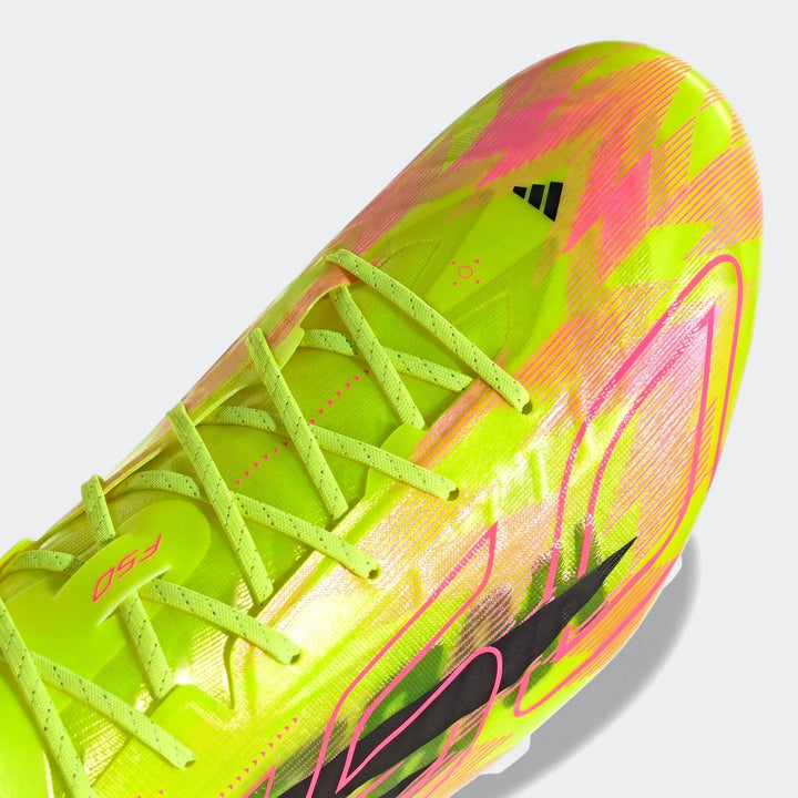 Close-up of a neon yellow and pink Adidas F50 Hyperfast Evo firm ground football boot, showing the toe and lacing.