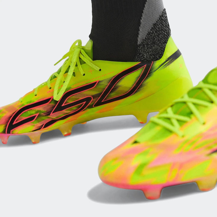 Close-up view of F50 Hyperfast Evo Firm Ground Football Boots in neon yellow and pink with black branding.