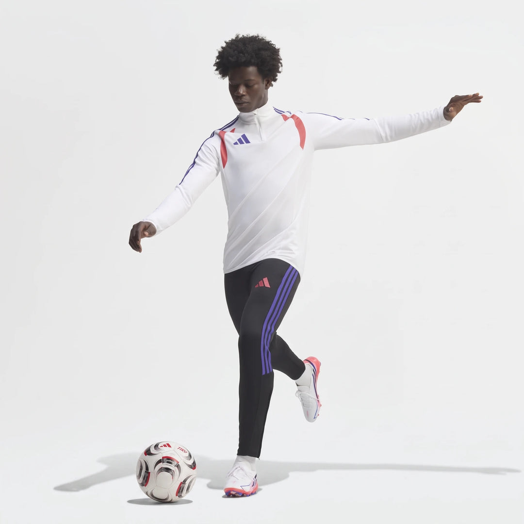 Male model wearing white and pink F50 Hyperfast League Firm Ground Football Boots, black training pants, and a white