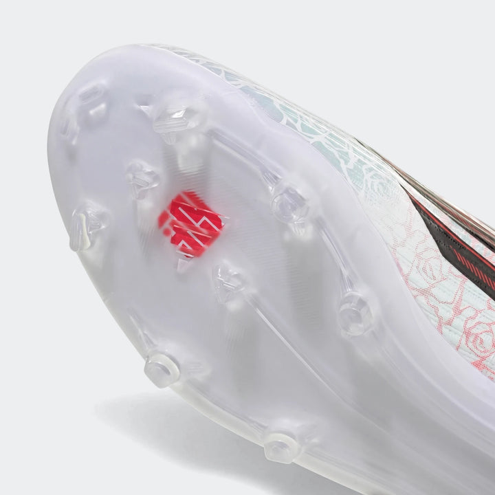 Close-up of the sole and patterned upper of a white F50 League Ll FG/MG Lamine Yamal kids football boot.