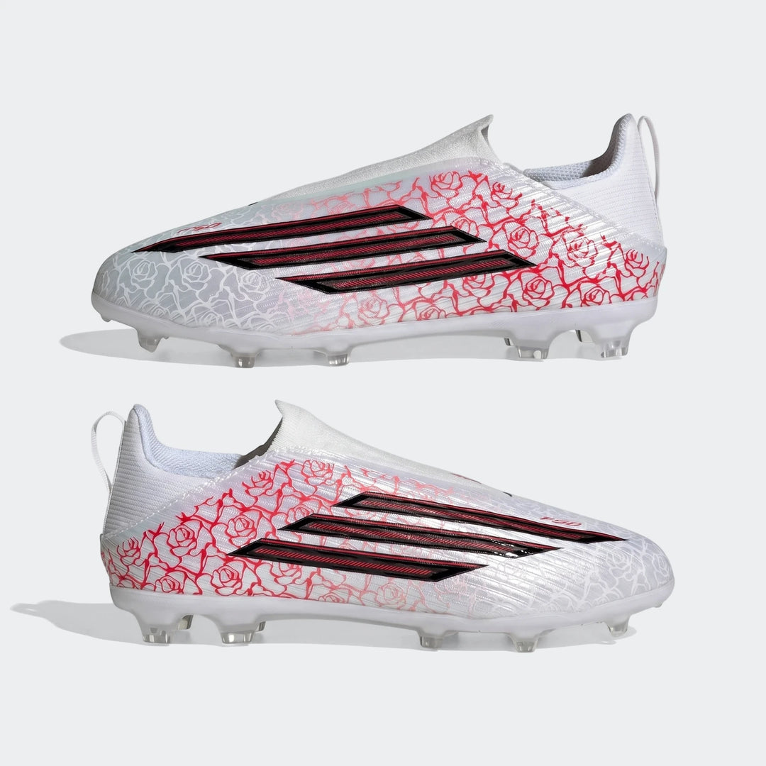 Two white Adidas F50 League Ll Fg / Mg Lamine Yamal kids football boots with red rose patterns and black stripes, side view.