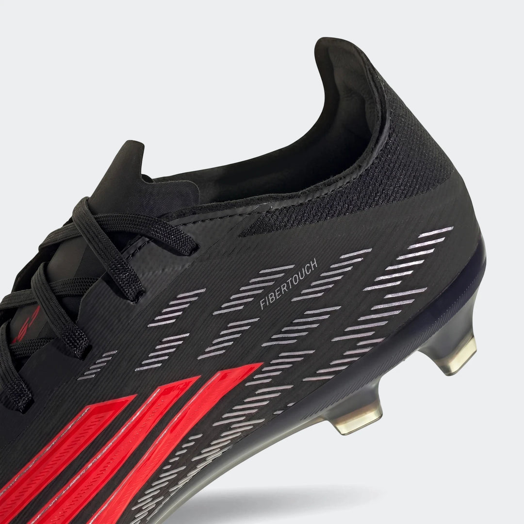 Close-up of a black and red Adidas F50 Pro Firm Ground Football Boot, showing the side view with 'FIBERTOUCH' text.