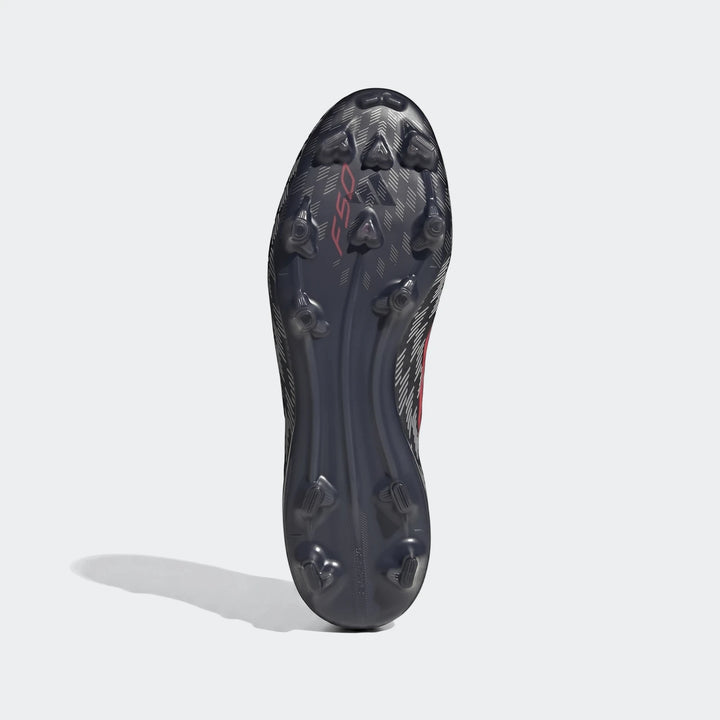 Bottom view of a dark grey and black F50 Pro Firm Ground Football Boot, showcasing the red F50 logo and numerous studs on