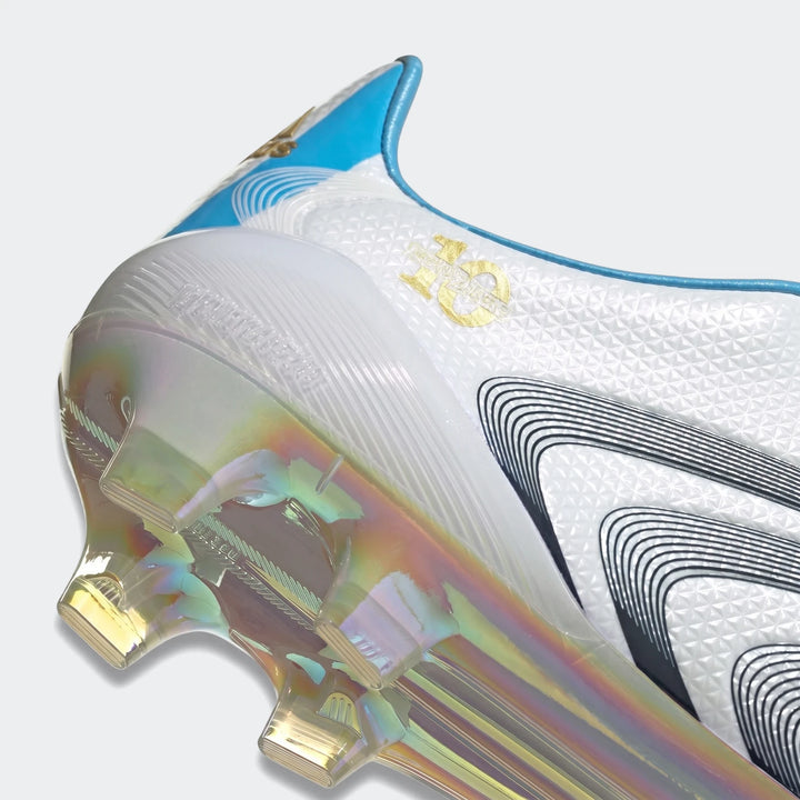 Close-up view of the F50 Tunit Firm Ground Football Boots in white with an iridescent sole and blue trim, featuring a golden