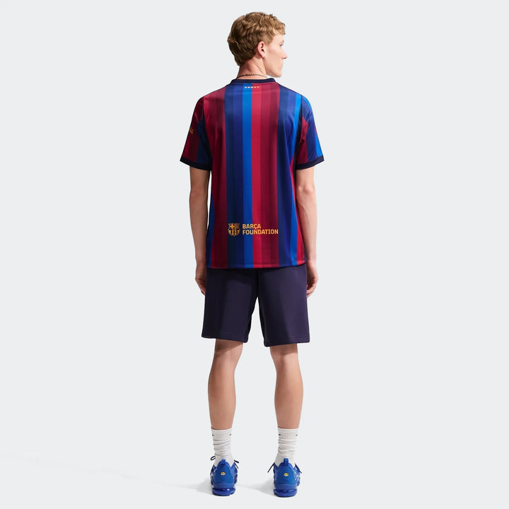 Back view of a male model wearing an Fc Barcelona 2026/27 Stadium Home Men'S Nike Dri-Fit Soccer Replica Jersey and dark