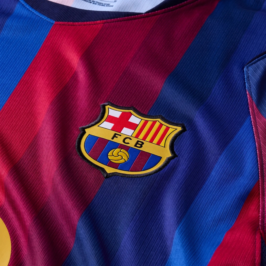 Close-up of an FC Barcelona 2026/27 Stadium Home Men's Nike Dri-Fit Soccer Replica Jersey in red and blue stripes with the