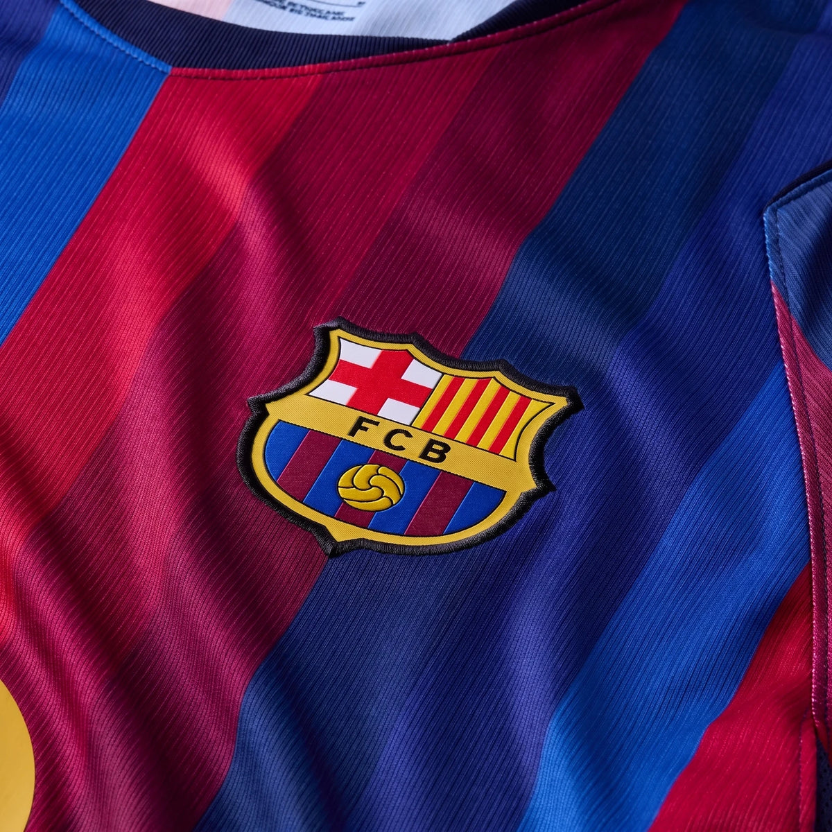 Close-up of an FC Barcelona 2026/27 Stadium Home Men's Nike Dri-Fit Soccer Replica Jersey in red and blue stripes with the