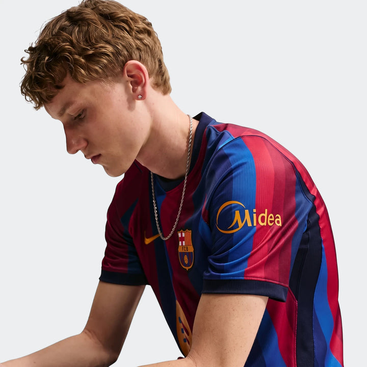 Man wearing a red and blue striped Fc Barcelona 2026/27 Stadium Home Men'S Nike Dri-Fit Soccer Replica Jersey, close-up.
