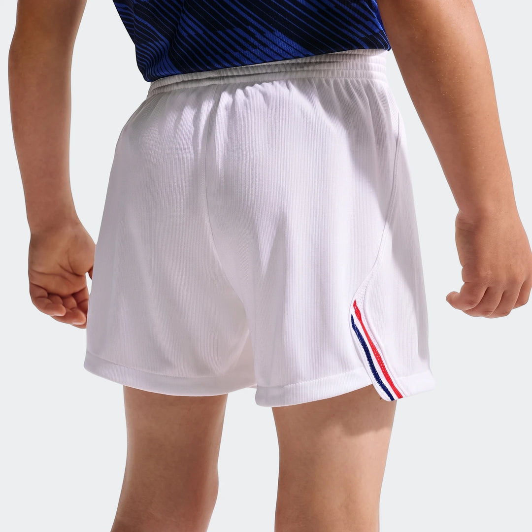 Back view of a child wearing white Fff 2026 Stadium Home Little Kids' Nike soccer replica shorts with blue, red, and white