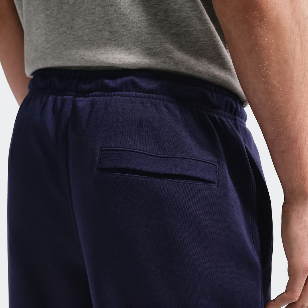 Close-up back view of Fff Club Blue Men's Nike Soccer French Terry Joggers, highlighting the navy blue fabric and back