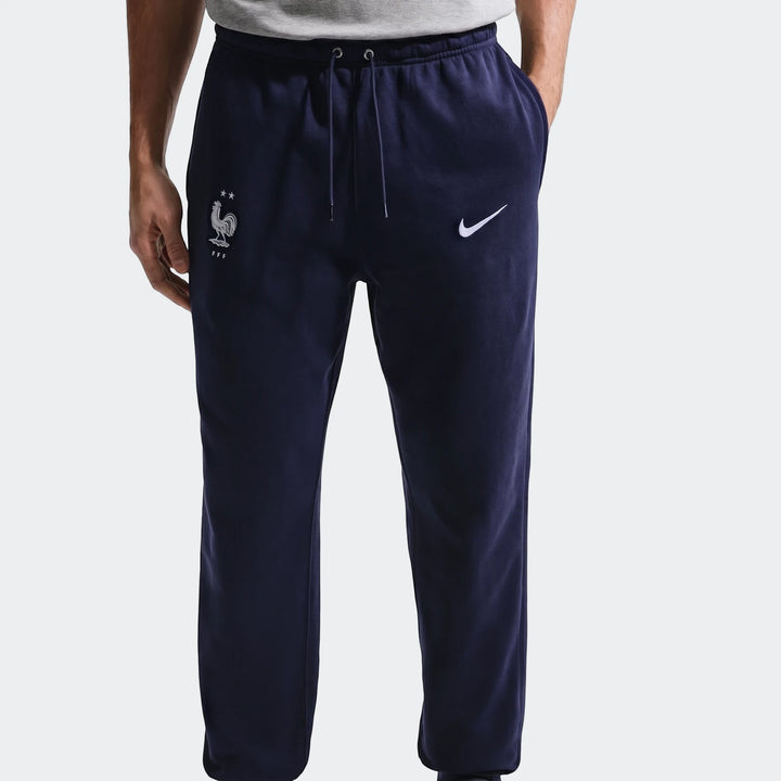Fff Club Blue Men's Nike Soccer French Terry Joggers, navy blue, worn by a model with hands in pockets.