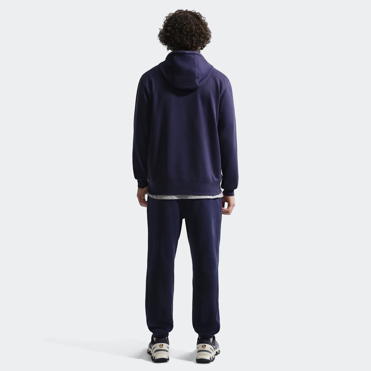 Fff Club Blue Men's Nike Soccer French Terry Pullover Hoodie and sweatpants, worn by a man from the back.