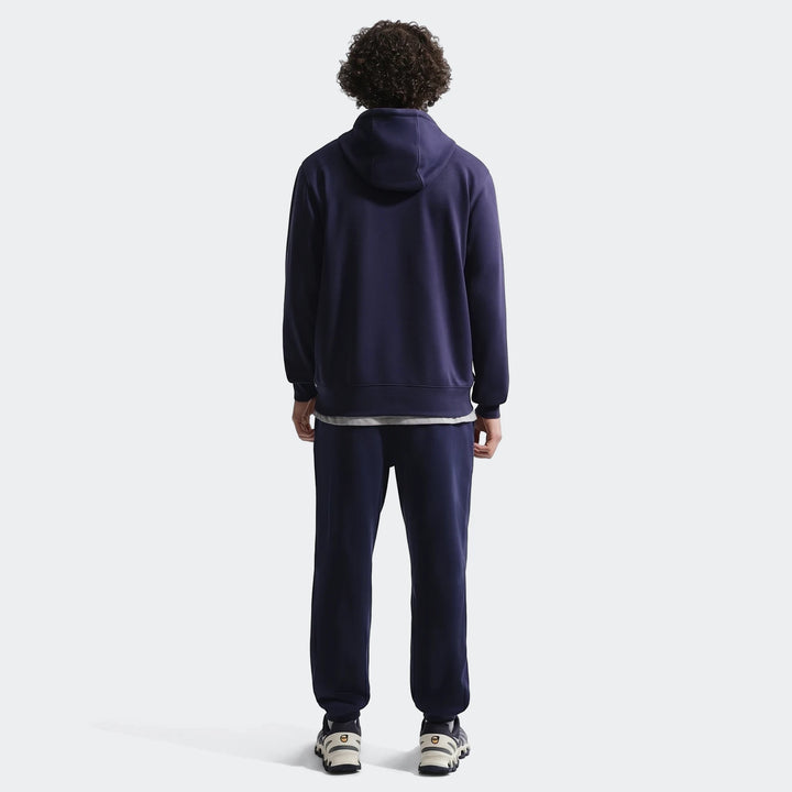 Fff Club Blue Men's Nike Soccer French Terry Pullover Hoodie and sweatpants, worn by a man from the back.