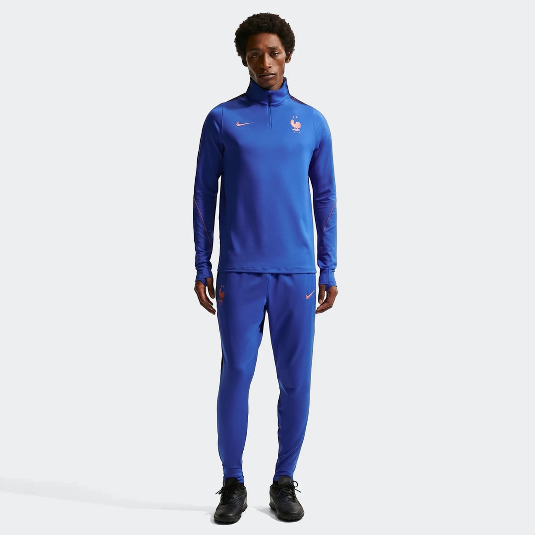 Blue Fff Strike Men's Nike Dri-Fit soccer knit pants and matching quarter-zip training top on a male model, front full-body