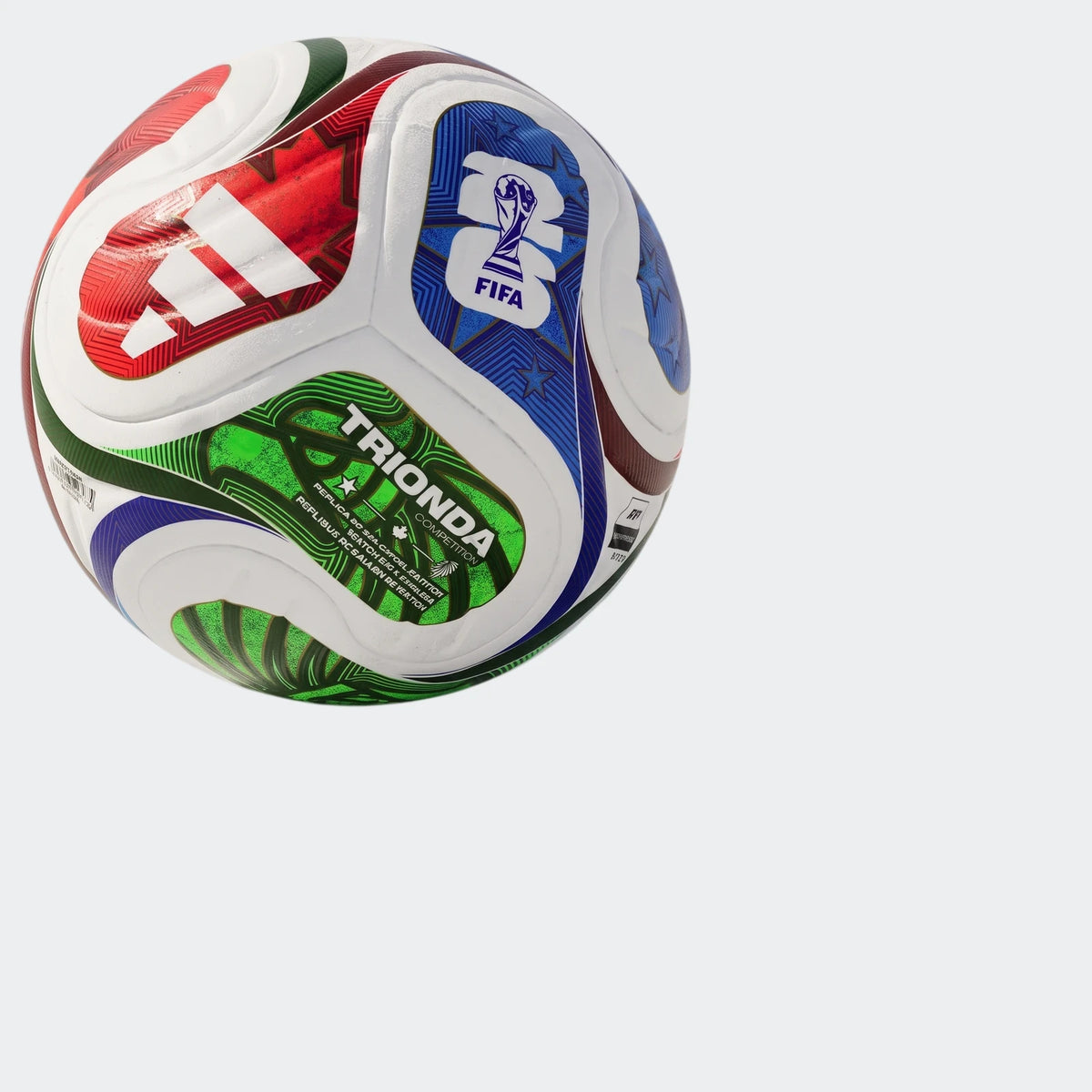 Fifa World Cup 26 Trionda Competition Ball with red Adidas logo and blue FIFA emblem, vibrant multi-color design on grass.