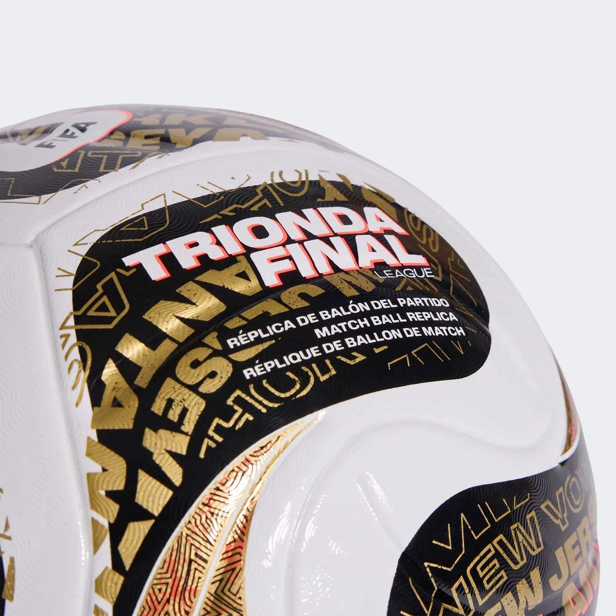 Close-up of a white, black, and gold Fifa World Cup 26™ Trionda Finals League replica soccer ball, showing logos and