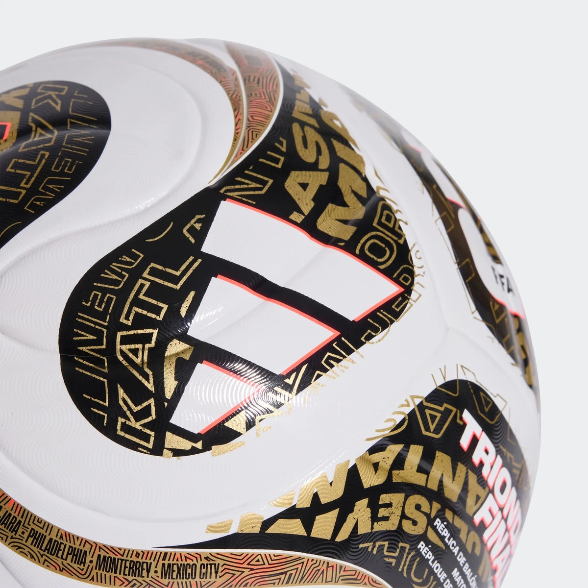 Close-up of the Fifa World Cup 26™ Trionda Finals League Ball, featuring its distinct white, black, gold, and red textured