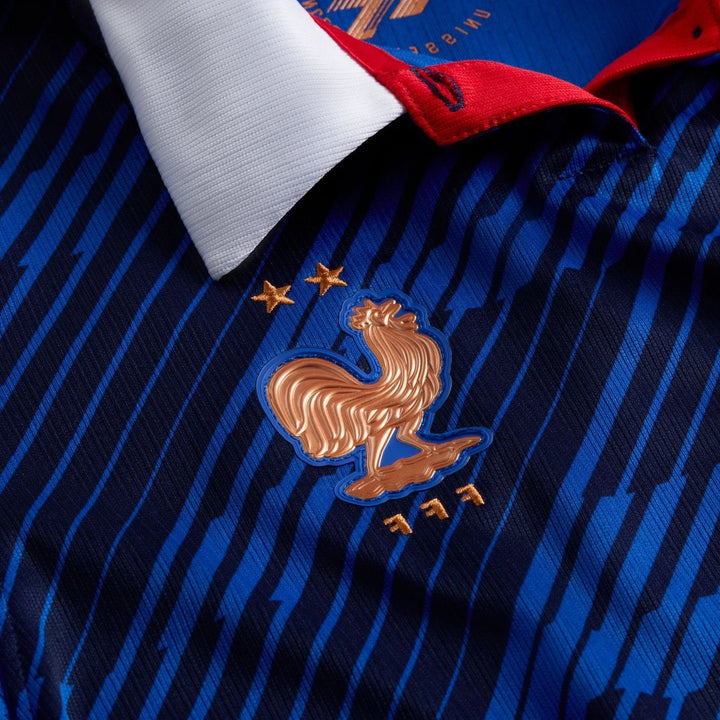 Close-up of the France National Team 2026 Stadium Home Blue Big Kids' Nike Dri-Fit Soccer Jersey, showing the golden rooster