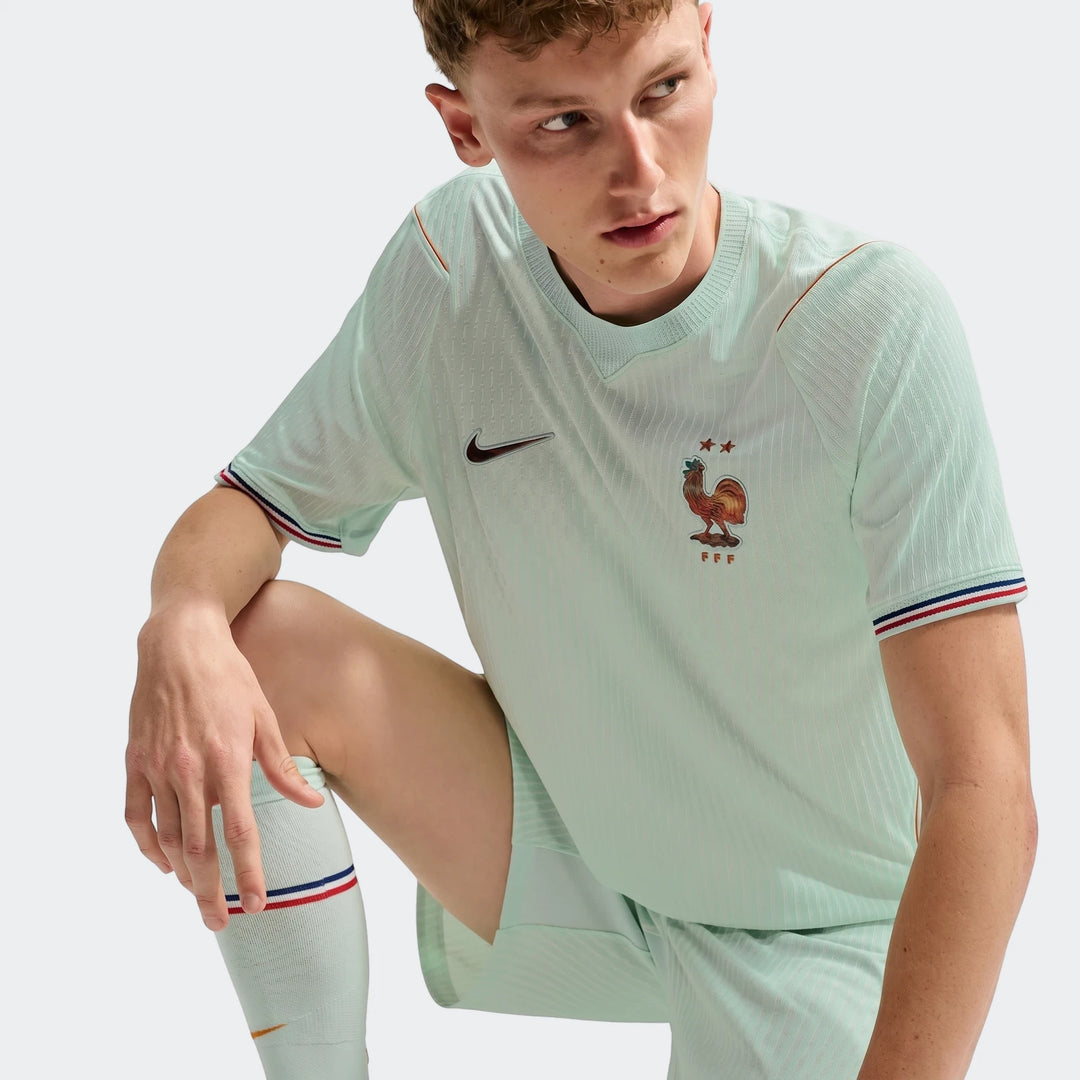 Male model wearing a mint green France National Team 2026 Match Away Nike Aero-Fit soccer jersey with FFF logo.