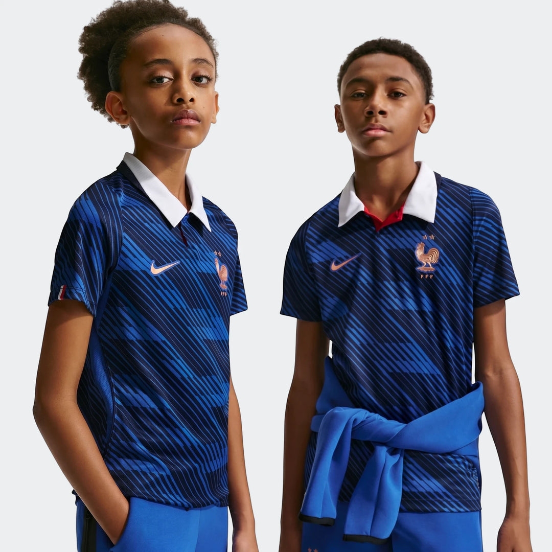 Two young boys model the France National Team 2026 Stadium Home Blue Big Kids' Nike Dri-Fit Soccer Jersey from the front.