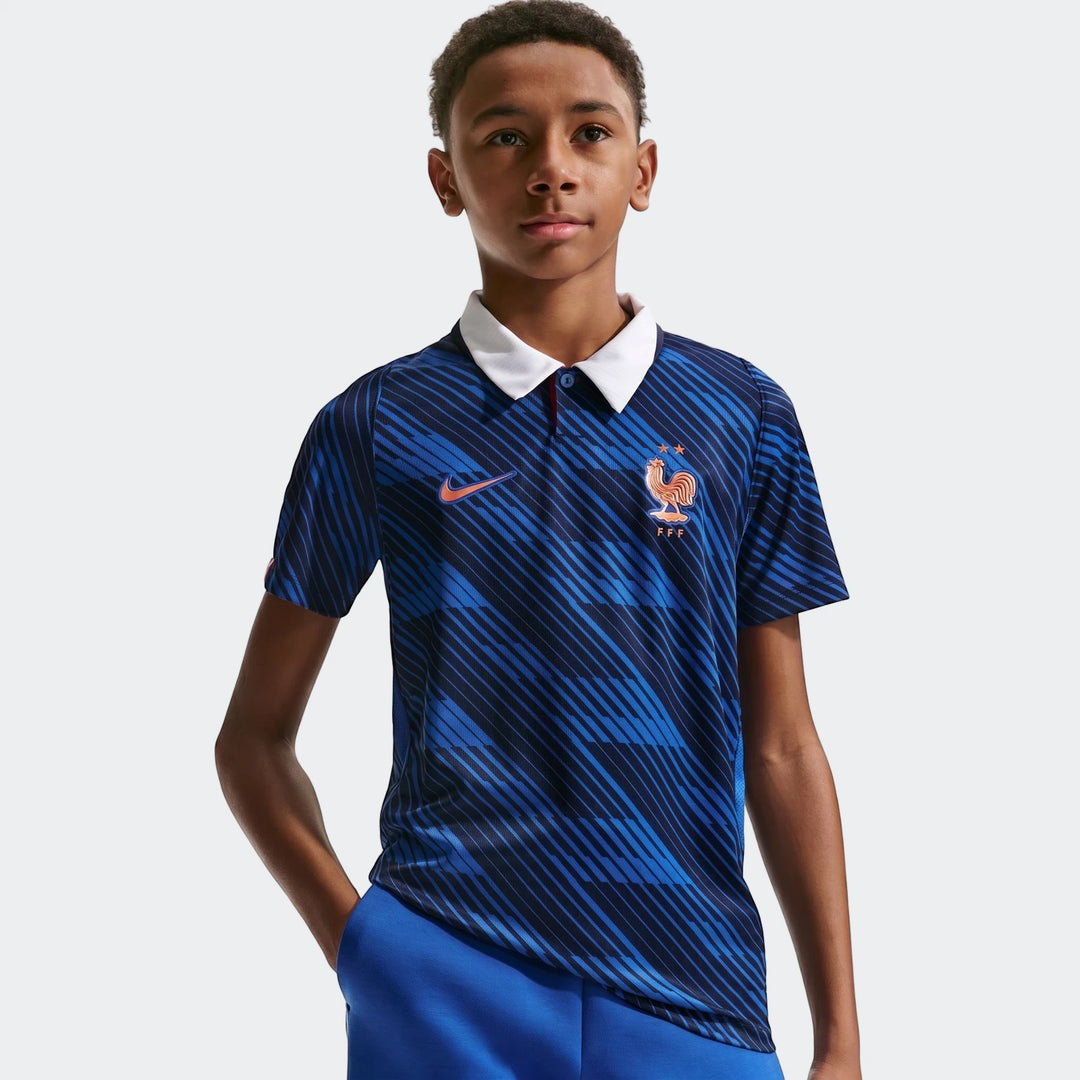 Young boy wearing a blue France National Team 2026 Stadium Home Nike Dri-Fit soccer jersey with diagonal stripes and a white