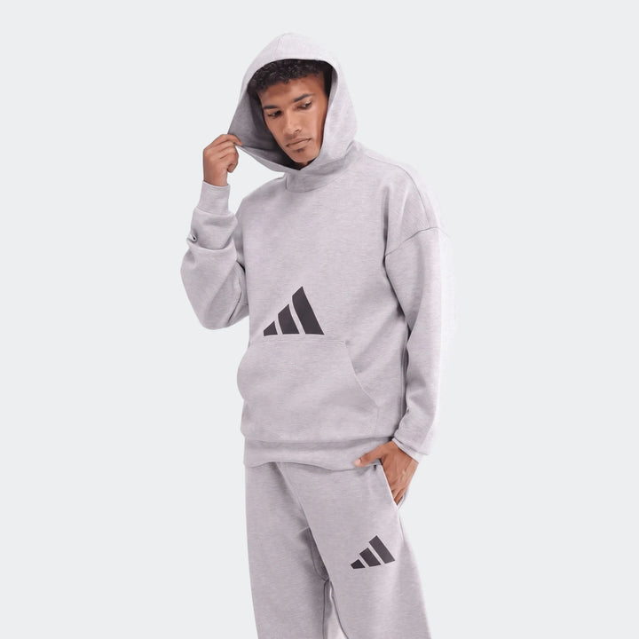 Future Icons 3-Bar Hoodie and matching sweatpants in light grey, worn by a male model, studio shot.