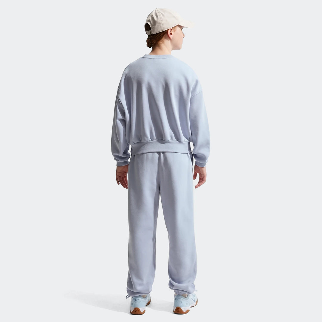 Person wearing light blue fleece sweatpants and matching sweatshirt with a beige baseball cap, viewed from the back.
