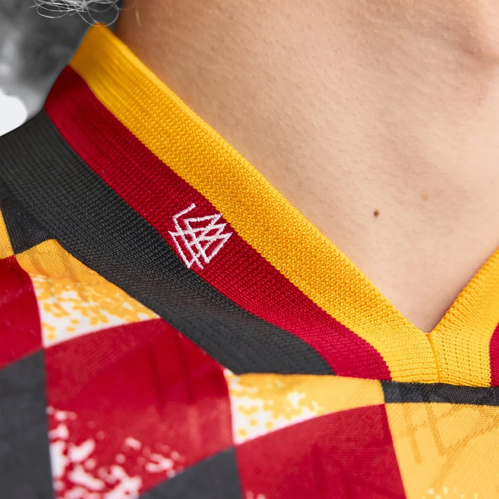 Close-up of a Germany 1994 Retro Home Jersey, featuring its distinctive knitted collar with yellow, red, and black stripes