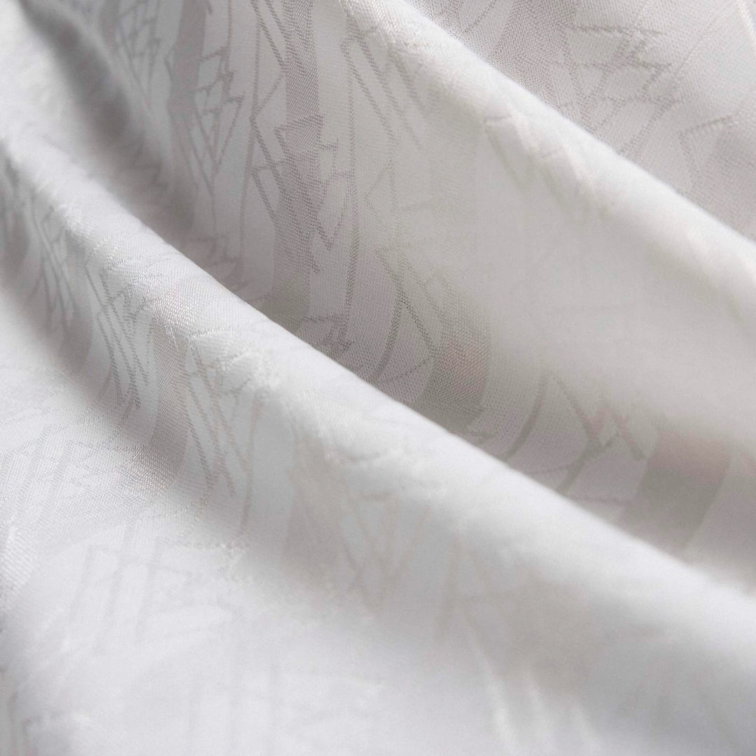 Close-up of a white Germany 1994 Retro Home Jersey fabric, showing its subtle geometric pattern and texture.