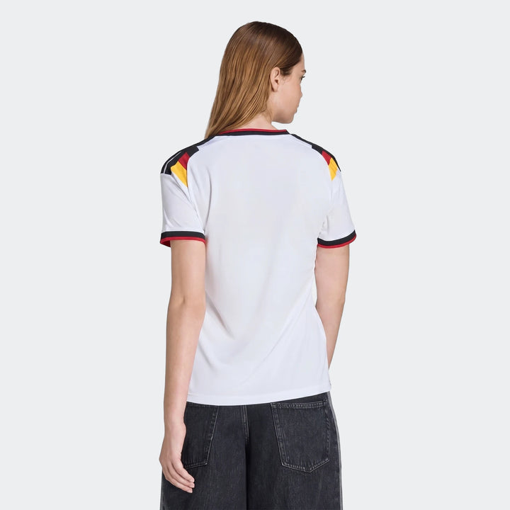 Women's Germany 25/26 Home Jersey in white, featuring black, red, and yellow shoulder details, modeled from the back.