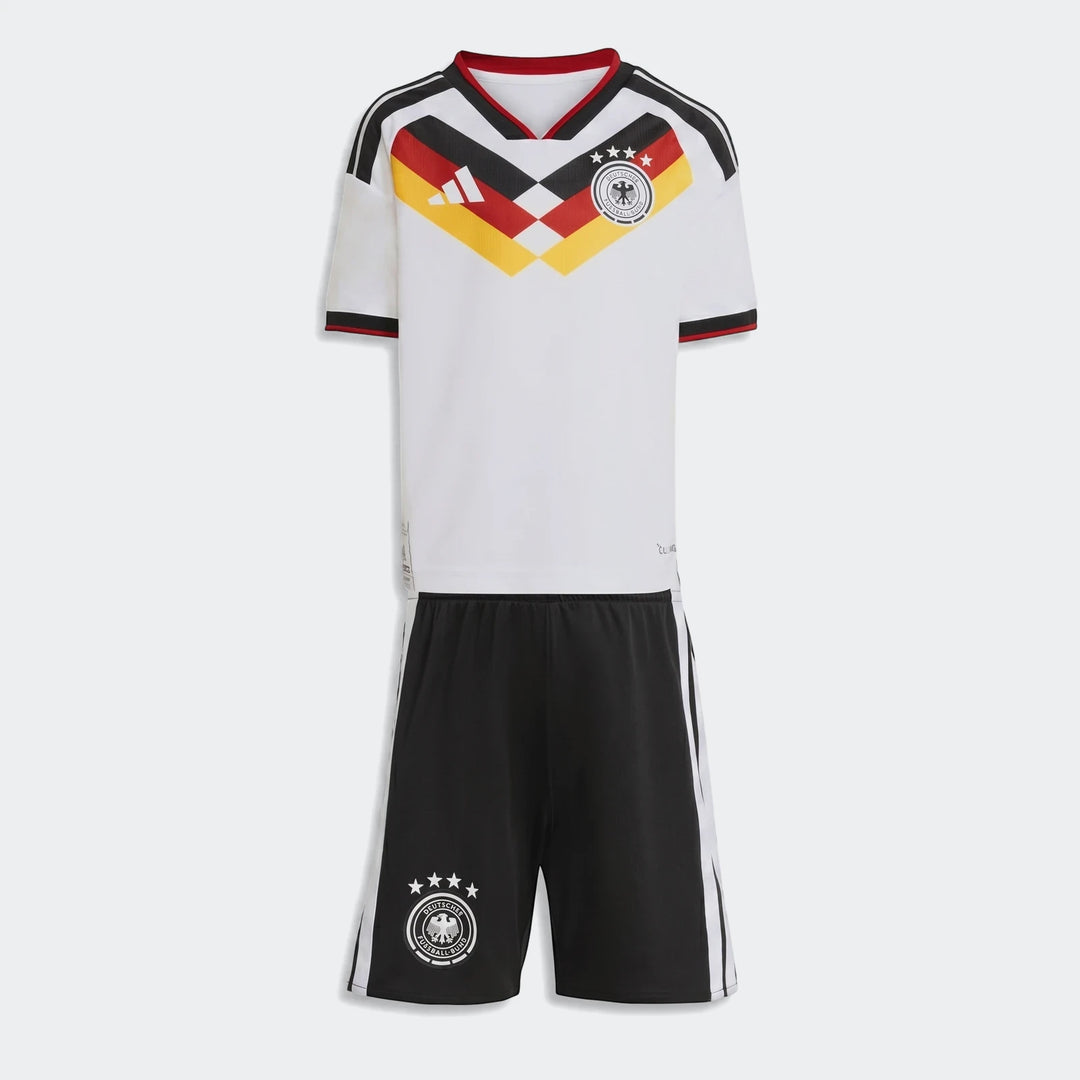 Germany 25/26 Home Mini Kit, white jersey with black, red, and yellow design, and black shorts laid flat.