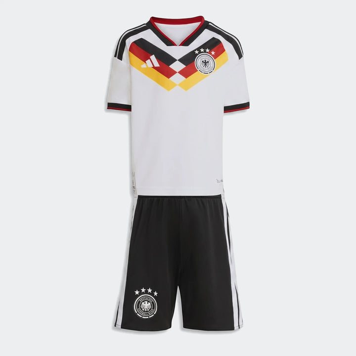 Germany 25/26 Home Mini Kit, white jersey with black, red, and yellow design, and black shorts laid flat.