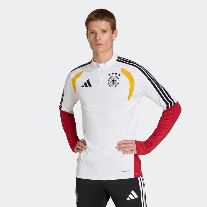 Germany 26 Tiro Training Top on a male model, featuring a white body, red sleeves, and black and yellow accents, front view.