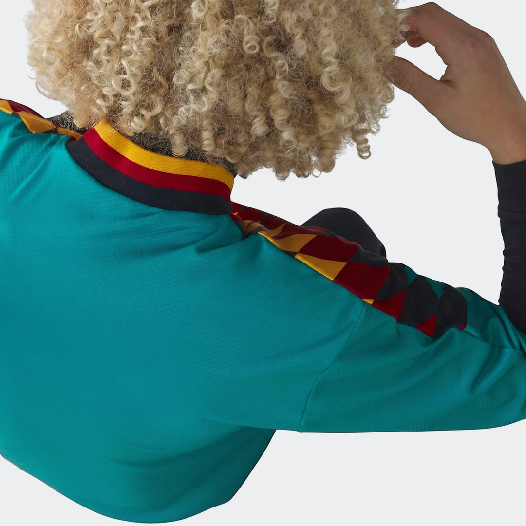 Back view of the 1994 Germany Away Jersey, a vibrant green shirt with a patterned sleeve and striped collar, worn by a