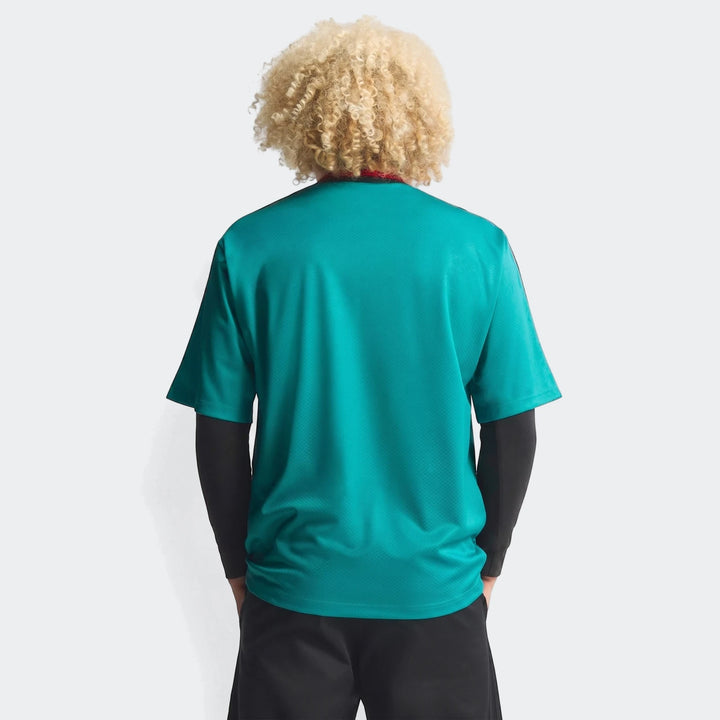 Germany Away Jersey 1994 in teal green, shown on a model from the back, highlighting the textured fabric and design.