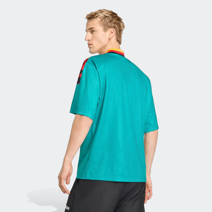 Germany Away Jersey 1994 in teal, worn by a male model shown from the back, looking over his shoulder.