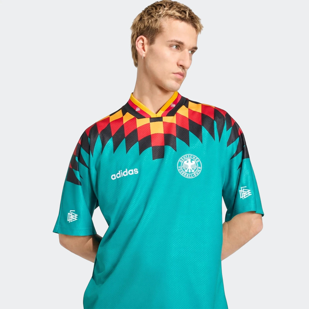 Germany Away Jersey 1994, teal with black, red, and yellow geometric pattern, worn by a male model.