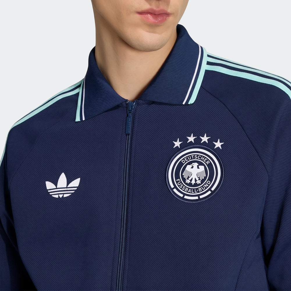 Germany Away Originals Jacket in navy blue, featuring an Adidas trefoil logo and the DFB emblem, worn by a model from the