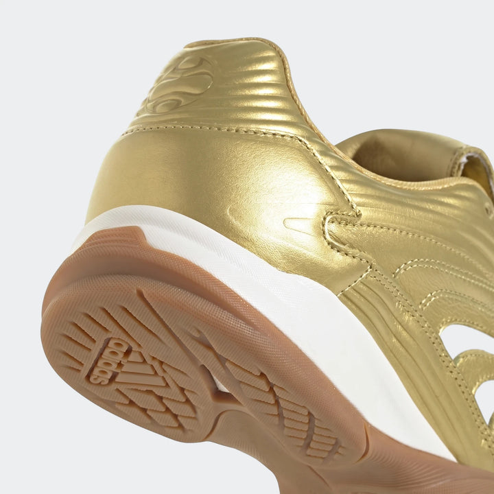 Close-up of a gold Predator Sala Indoor Football Boot, featuring the textured gum sole and heel design.