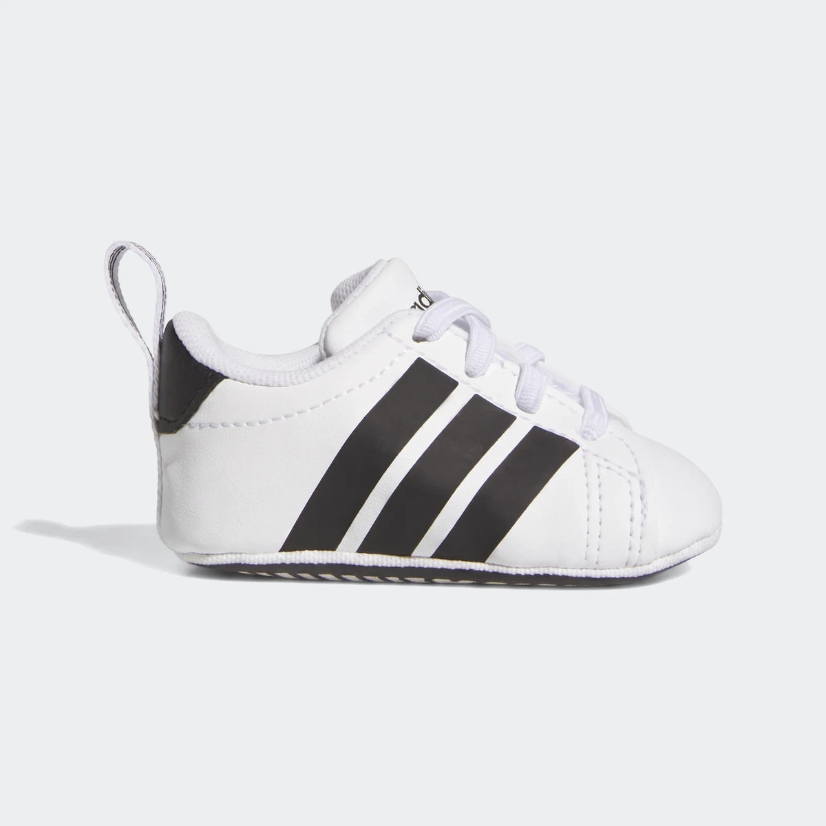 White Adidas Grand Court crib shoes with three black stripes, shown from the side, designed for infants.
