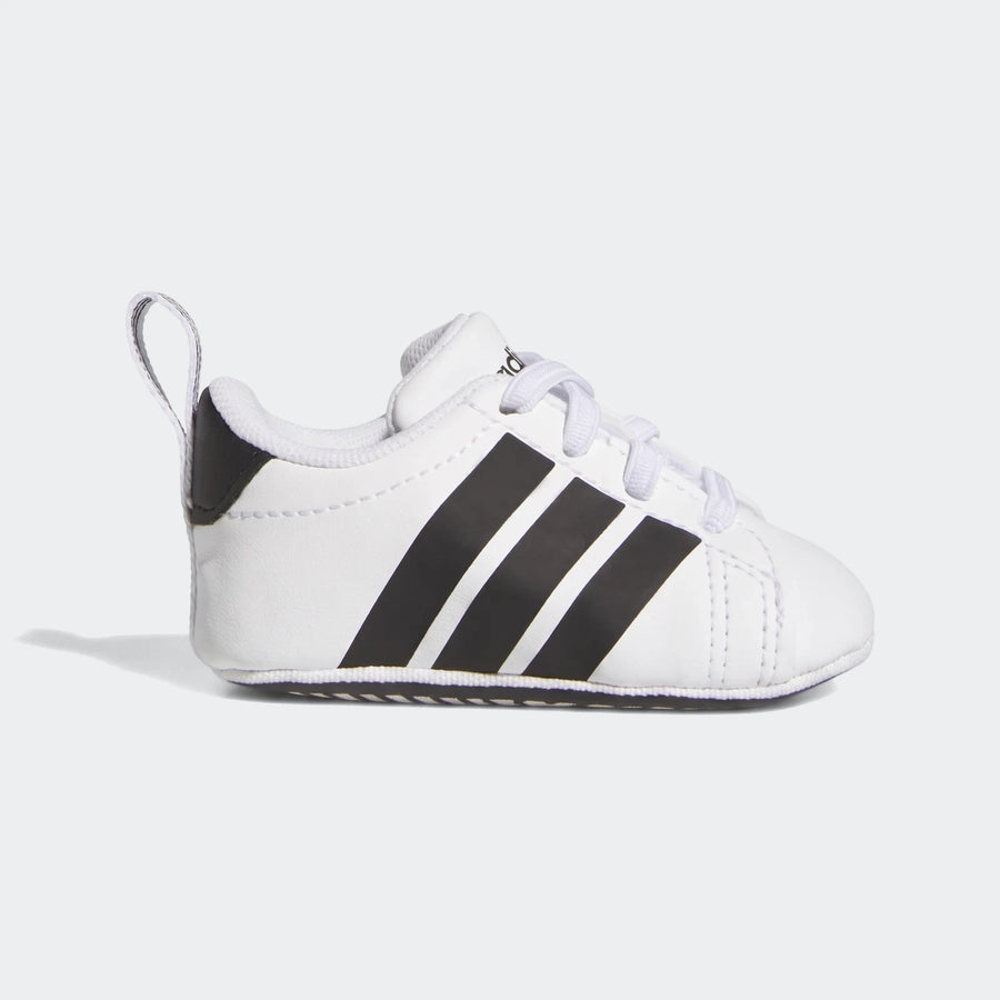 White Adidas Grand Court crib shoes with three black stripes, shown from the side, designed for infants.