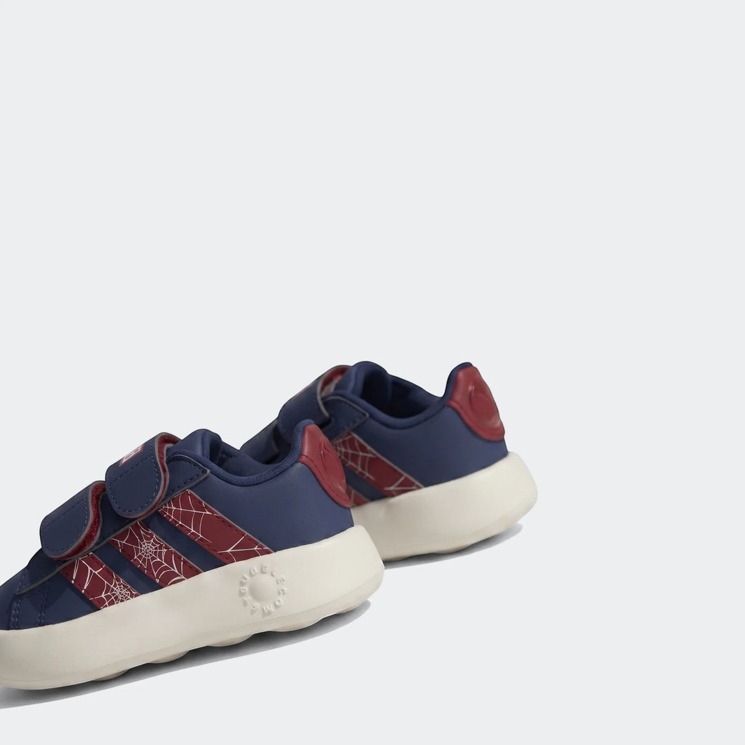 Low-angle view of navy blue and red Grand Court Spider-Man Cloudfoam Kids Shoes on concrete, featuring spider web stripes