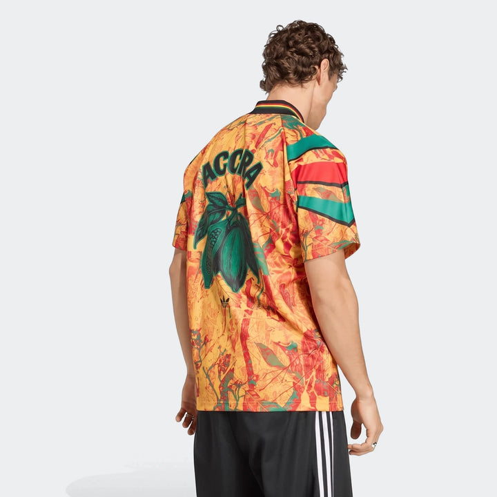 Men's Graphic Football Jersey with vibrant yellow, red, and green pattern, 'ACCRA' text, and cocoa bean graphic on the back.