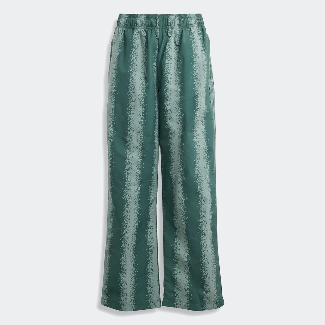 Green patterned adidas Sst Loose Track Pants with an elastic waistband and subtle logo, displayed flat, featuring vertical