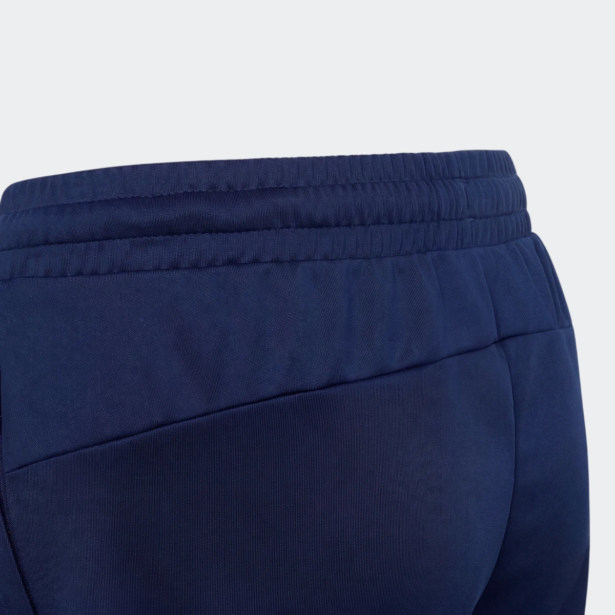 Dark blue House Of Tiro shorts, captured in a close-up view highlighting the ribbed waistband and diagonal seams on the hip.