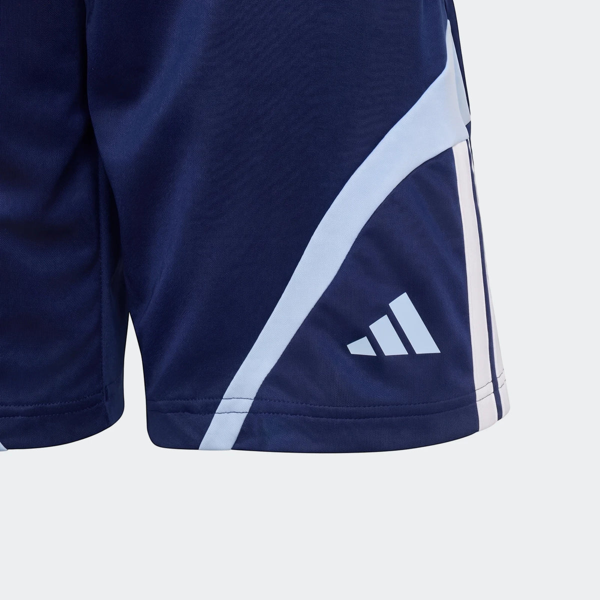 Close-up of navy blue Adidas House Of Tiro shorts with light blue and white stripe detail, showing fabric texture and logo.