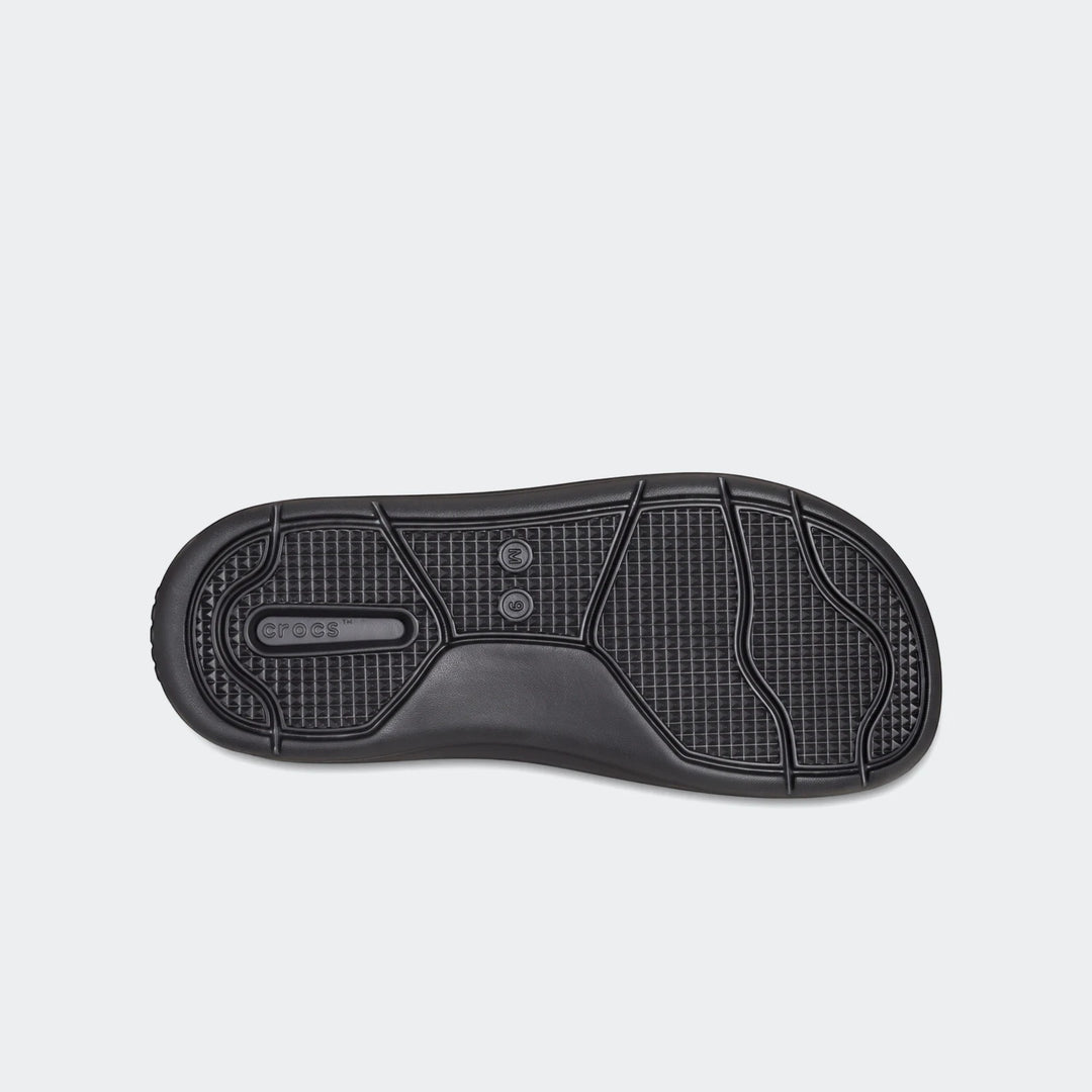 In Motion Lite Ride black Crocs flip flops, showing the detailed bottom sole with textured grip.