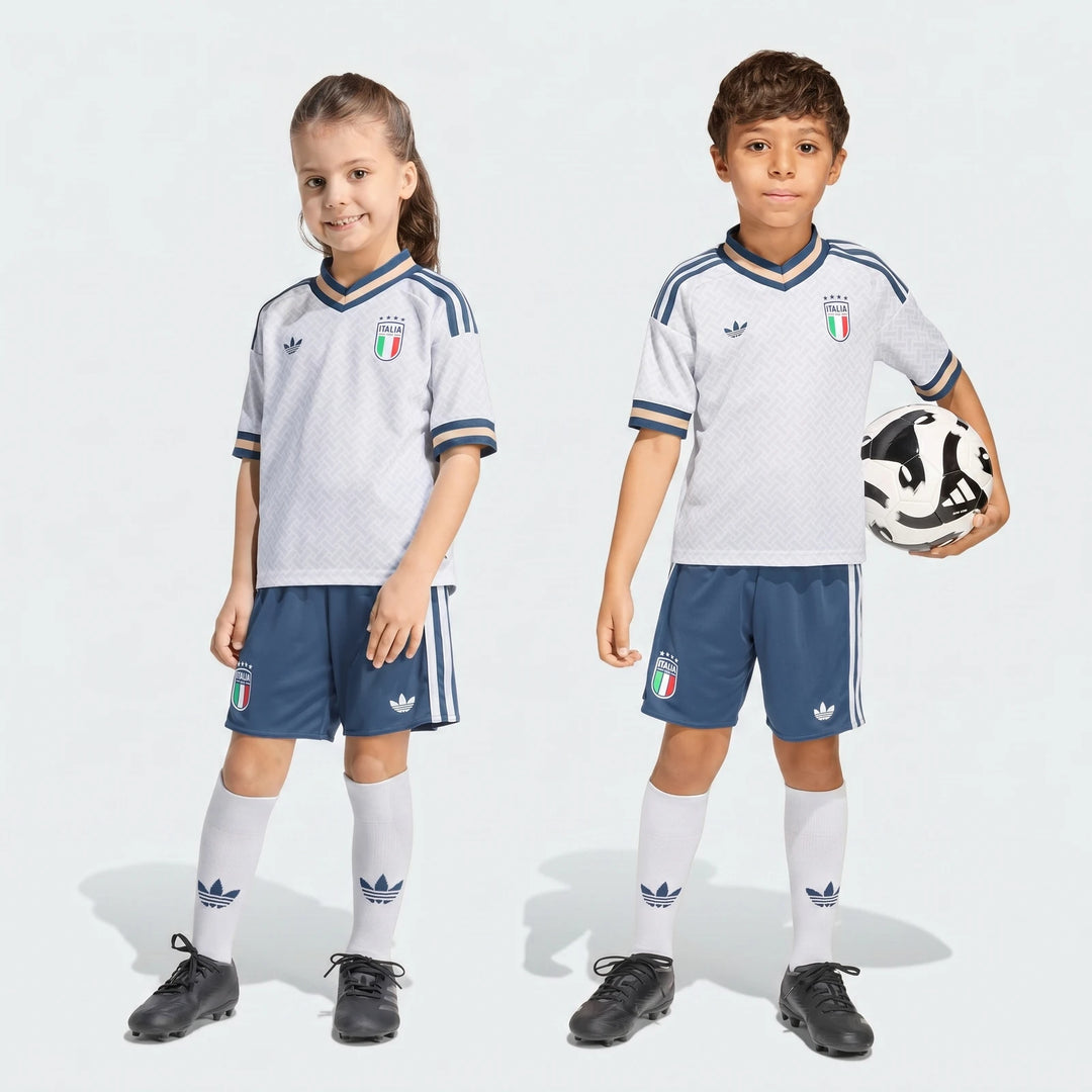 Italy 25/26 Away Mini Kit for kids, featuring a white jersey, blue shorts, white socks, and a soccer ball, full body studio